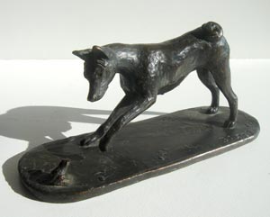 Basenji with frog sculpture