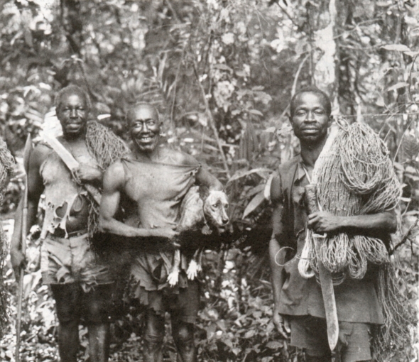Three Azande hunters with woven nets and machetes, one holding the brindle dog Bobi